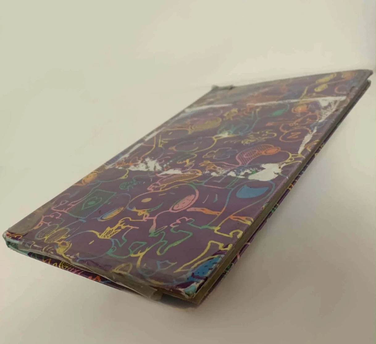 The Announcement Logbook: a hardbound notebook with a purple, hand-doodled cover